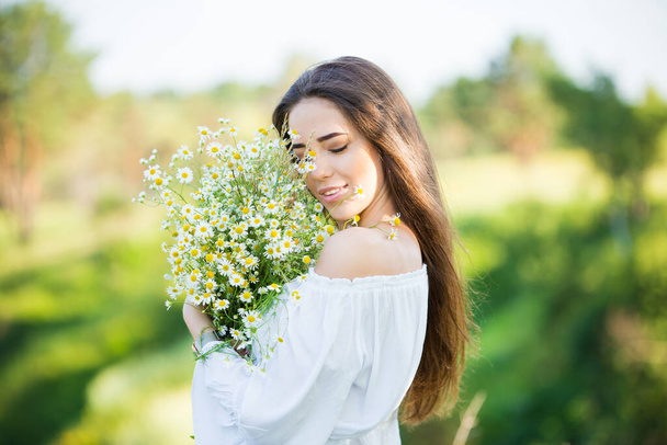 portrait of a beautiful young girl with bouquet, outdoors, in the field - Foto, afbeelding
