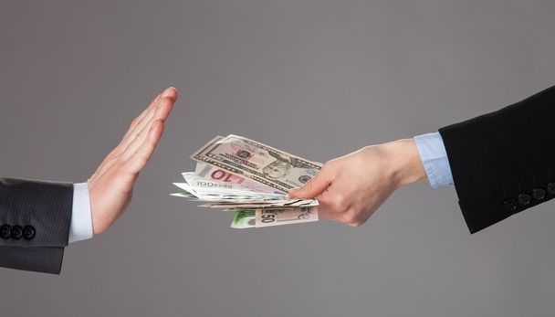 Businessman's hand rejecting a bribe - Foto, afbeelding