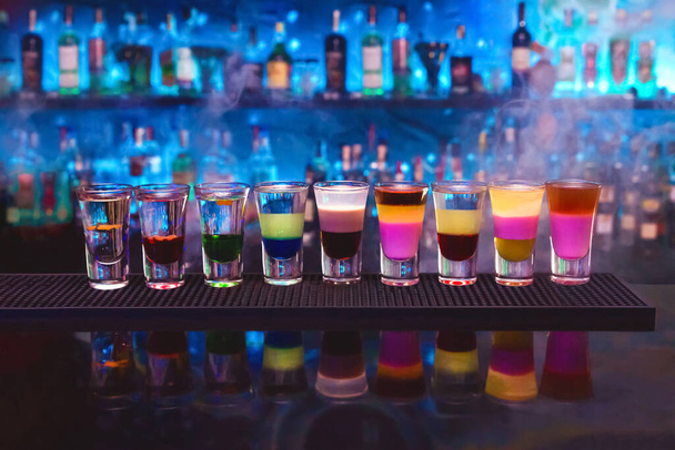 Set of different alcoholic shots cocktails on club bar background - Photo, Image