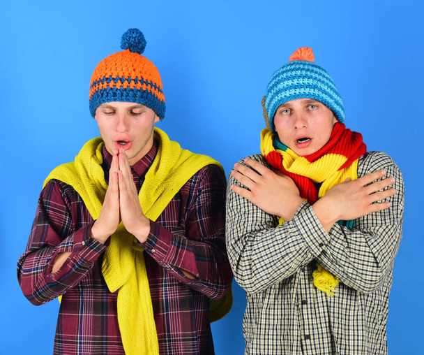 Men with sad faces on blue background. Siblings are cold - Foto, immagini