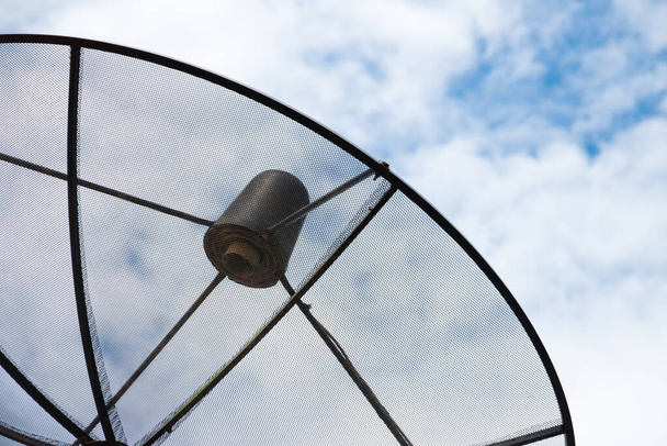 Close up black antenna communication satellite dish on cloudy sky background, network connection technology - Photo, Image