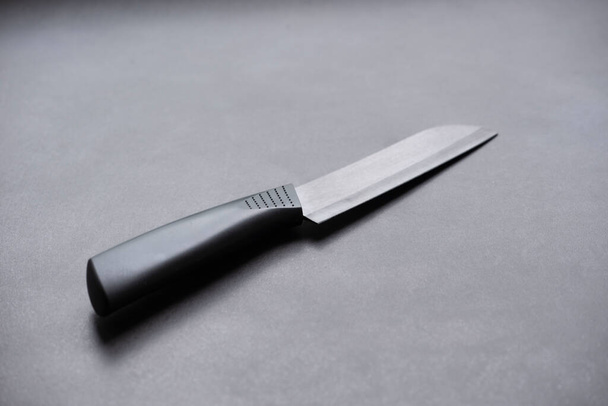 black knife on a black stone background - Фото, изображение