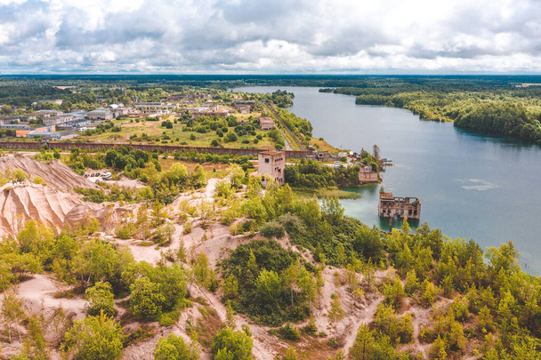 Aerial view of the Rummu abandoned prison Tallinn Estonia lake beach. Beautiful view of the forest, lake and old prison remains most of which are under water. - Photo, Image