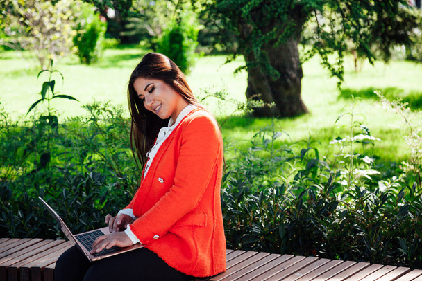 Beautiful Asian brunette working with laptop online - Fotografie, Obrázek