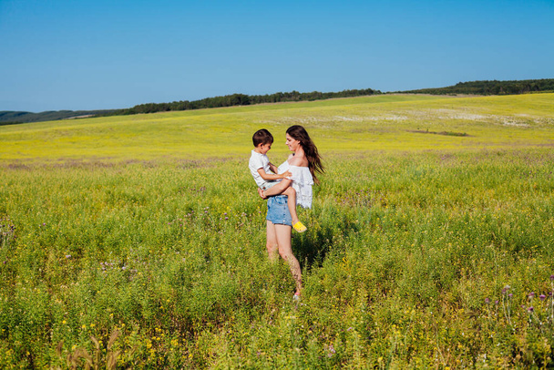 Retrato de una hermosa madre e hijo en un paseo por la naturaleza camino de campo
 - Foto, imagen