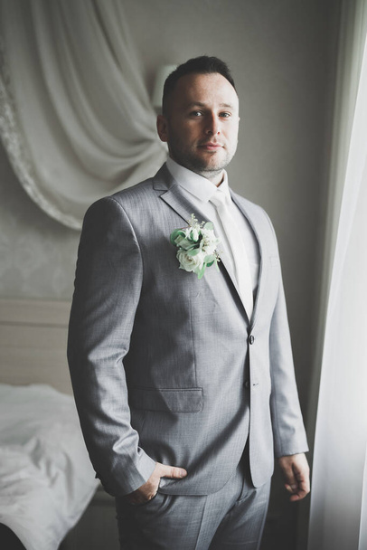 Beautiful man, groom posing and preparing for wedding - Фото, изображение