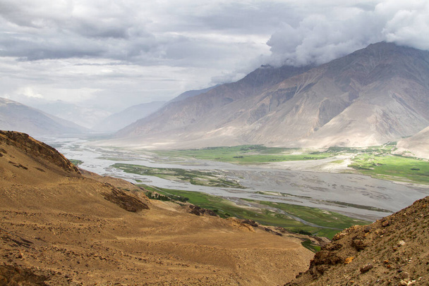 Wakhan coridor. Divided by Panj river (Amu Darya) next to Pamir highway on Marco Polo silk road. Gorno Badakhsan province, Tajikistan, Central Asia - Photo, Image