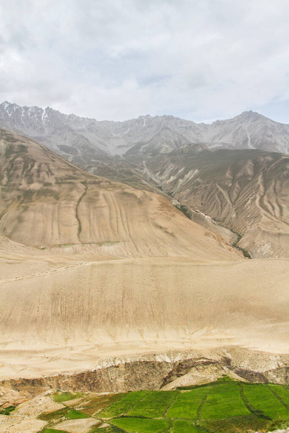 Wakhan coridor. Divided by Panj river (Amu Darya) next to Pamir highway on Marco Polo silk road. Gorno Badakhsan province, Tajikistan, Central Asia - Photo, Image