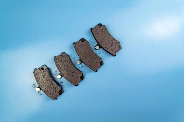Auto parts, brake discs, pads. Brake pads on a blue background - Photo, Image