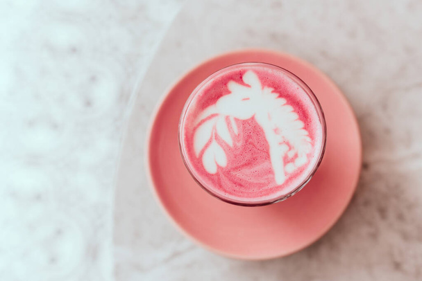 trendy beetroot latte with latte art and flower petals - Photo, Image