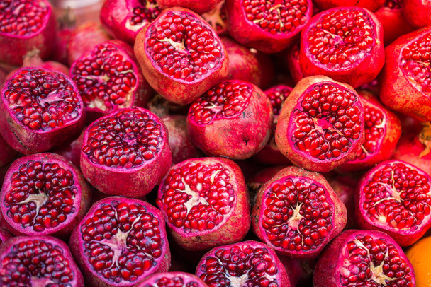Pomegranates for pomegranate juice at the fruit market counter. - Photo, Image