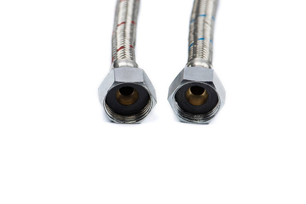 Metal hoses connecting hot and cold water on a white background, selective focus. - Photo, Image