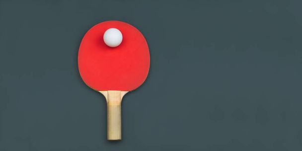 Red table tennis racket with a ball isolated on a colored background. sport equipment for ping pong. copy space - Foto, Imagen