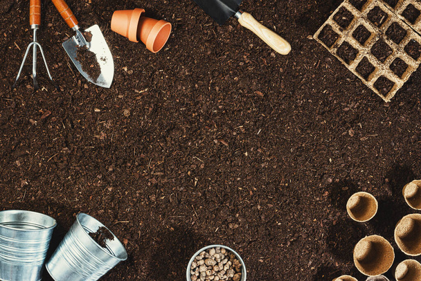 Gardening tools on soil background. Working in the garden - Fotó, kép