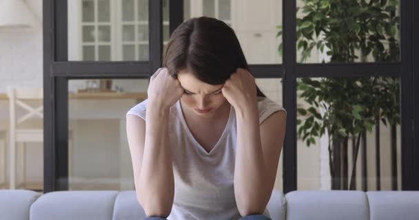 Upset miserable young woman crying alone at home feeling depressed - Materiał filmowy, wideo