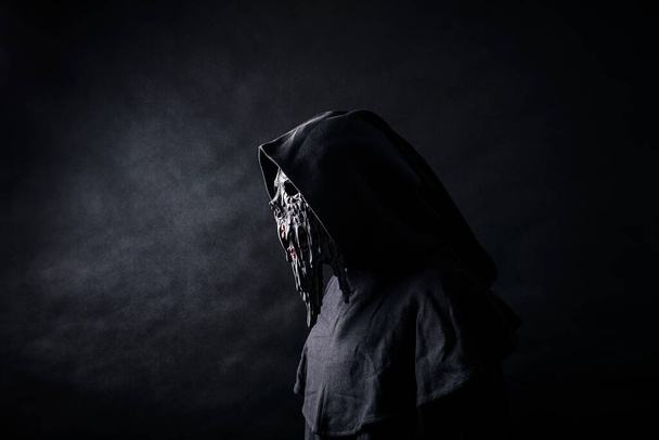 Scary figure in hooded cloak with mask - Fotoğraf, Görsel