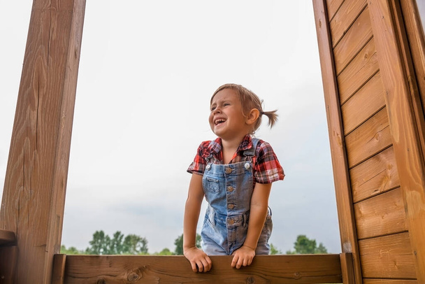 Portrait of a Cute little girl in a red white shirt against the sky. - Foto, Bild
