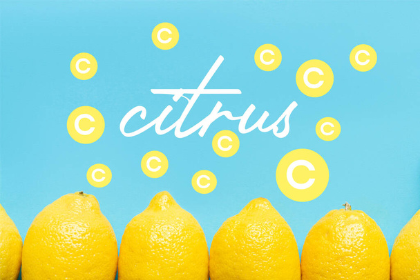 bovenaanzicht van rijpe gele citroen op blauwe achtergrond met citrusfiltratie - Foto, afbeelding