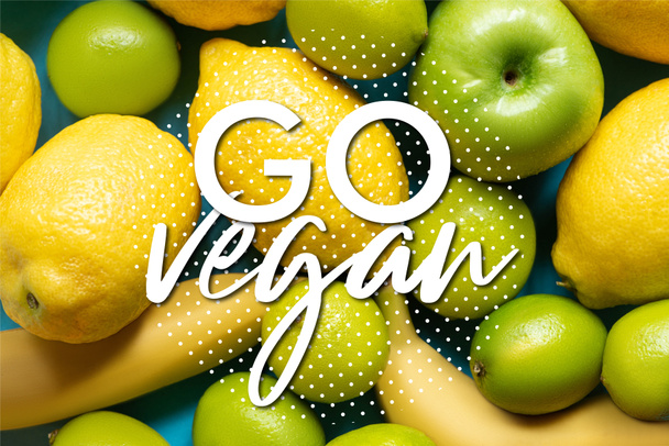 top view of yellow lemons, bananas, green apples and limes, go vegan illustration - 写真・画像