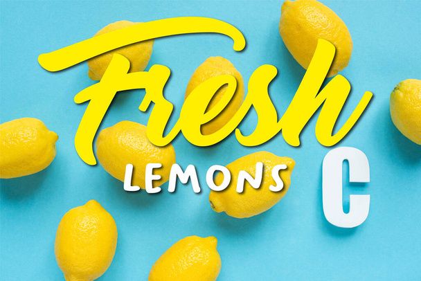 top view of ripe yellow lemons and letter C on blue background, fresh lemons illustration - Photo, image