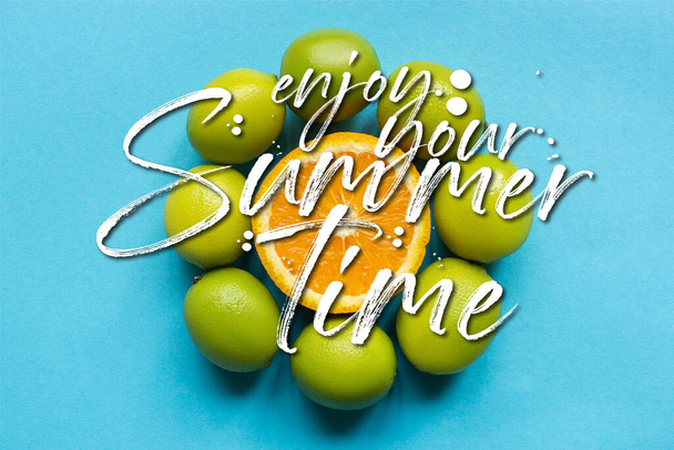 top view of ripe orange and limes arranged in circle on blue background, enjoy your summertime illustration - Foto, Imagem
