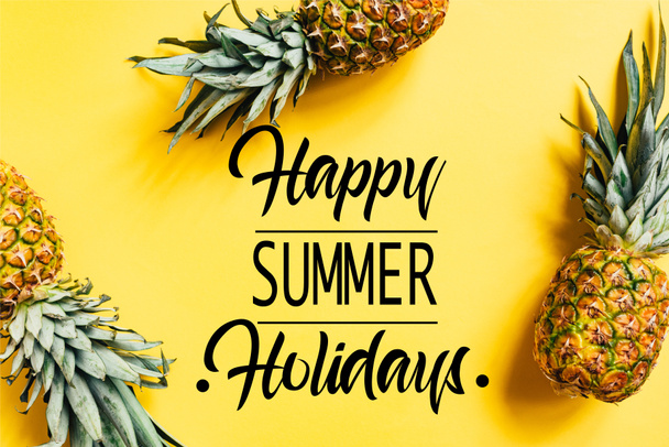 top view of fresh tasty pineapples on yellow background with happy summer holidays illustration - Photo, Image