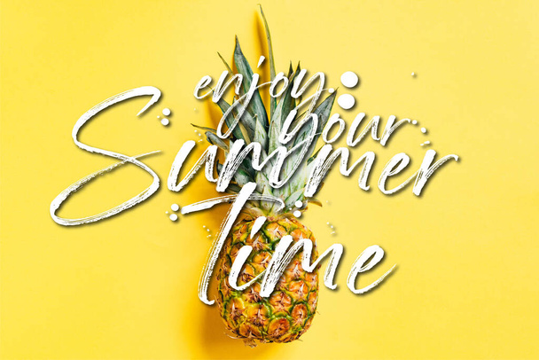 top view of fresh ripe pineapple on yellow background with enjoy your summertime illustration - Foto, Imagem