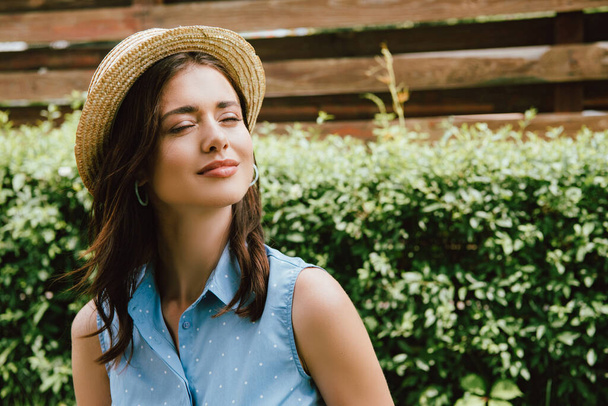 happy young woman with closed eyes in straw hat  - Photo, Image