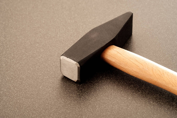 Large new metal hammer on a ceramic surface. punching tool - Fotoğraf, Görsel