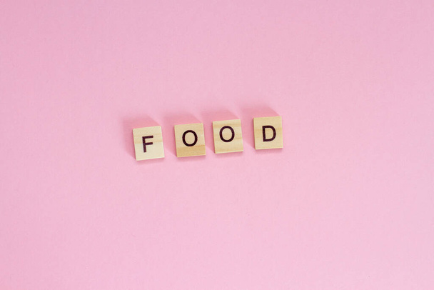 Wooden cubes inscription FOOD on pink background - Photo, image