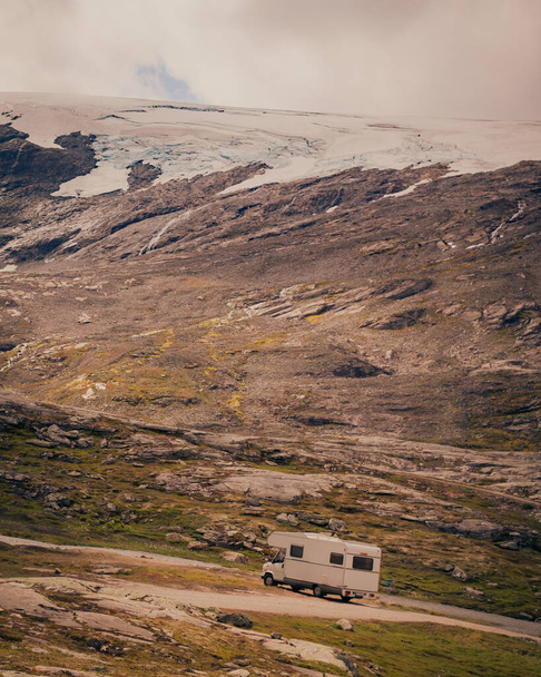 Camper car in norwegian mountains. Camping on nature. Traveling, holidays and adventure concept. - Fotografie, Obrázek