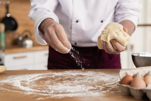 Making dough by male hands at bakery - 写真・画像