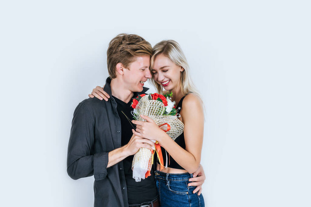 Portrait of happy young couple love together with flower in studio - Photo, Image