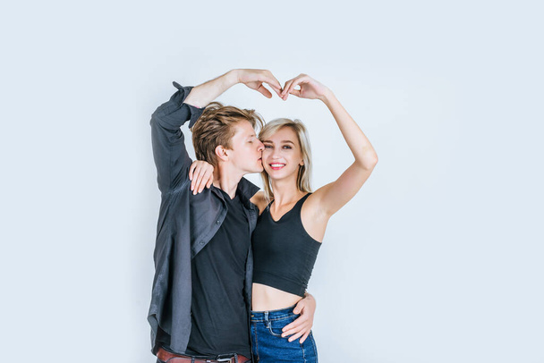 Portrait of happy young couple love together in studio - Photo, Image