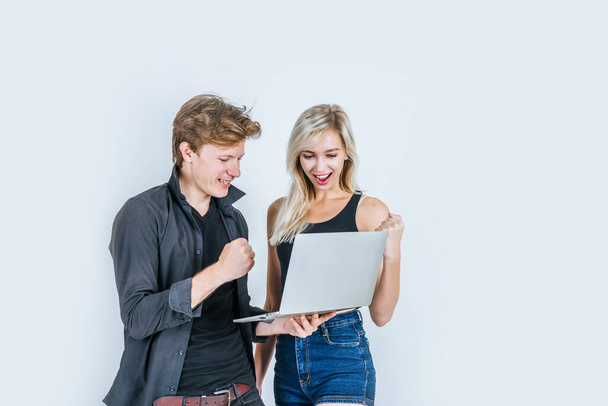 Portrait of happy young couple using laptop computer in studio - Foto, Imagem