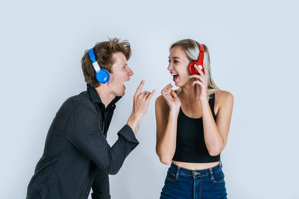 happy young couple in headphones listening music in studio - Фото, изображение