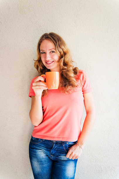 Beautiful and smiling woman with a cup of coffee - Zdjęcie, obraz