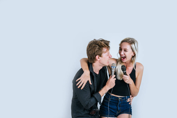 Happy portrait of Couple holding microphone and sing a song - Foto, afbeelding
