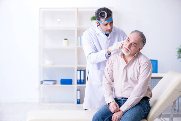 Paciente masculino que visita al médico otorrinolaringólogo - Foto, imagen