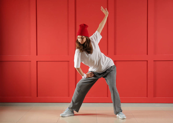 Mooie vrouwelijke hip-hop danser tegen kleur muur - Foto, afbeelding