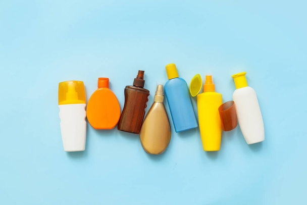 Bottles of sunscreen on color background - Photo, Image