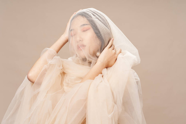 Woman with transparent cloth on her face wedding ceremony makeup  - Φωτογραφία, εικόνα