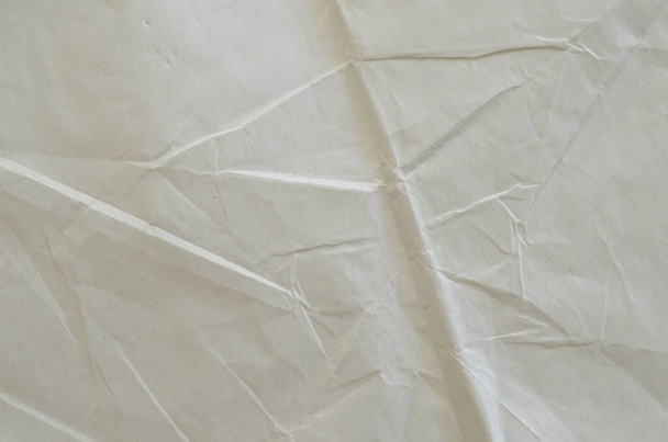 Creative background with scattered overlay of crumpled white paper. - Фото, изображение