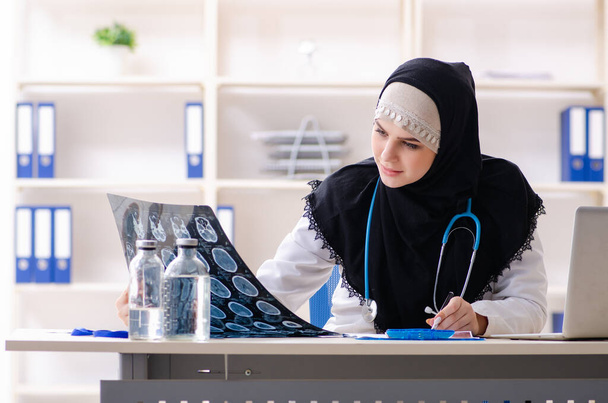 Young doctor in hijab working in the clinic - Фото, изображение