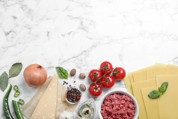 Fresh lasagna ingredients on white marble table, flat lay. Space for text - Foto, immagini