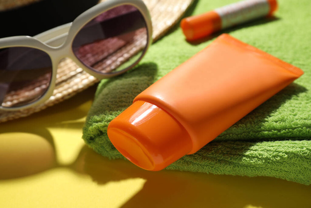 Tube of sun protection cream on towel, closeup - Φωτογραφία, εικόνα