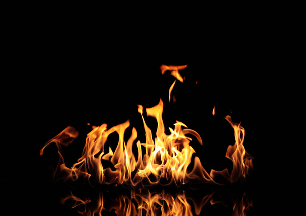 Beautiful bright fire flames on black background - Foto, afbeelding