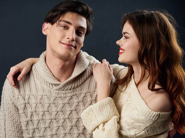 Pretty woman hugs a handsome guy in a fashionable sweater - Photo, Image