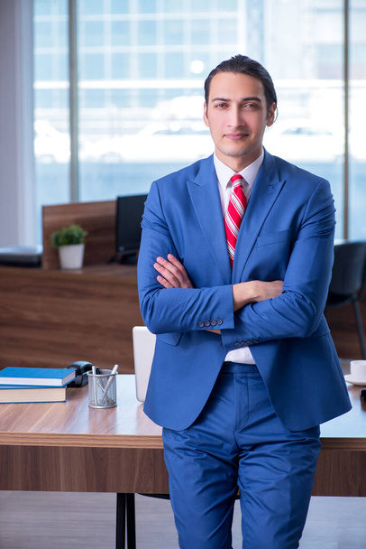 Young handsome businessman sitting in the office - Fotografie, Obrázek