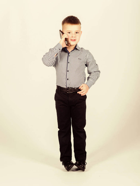 Modern gadget. Small businessman. Upbringing and development. Little boy formal clothes call mobile phone. Cute boy hold smartphone. Mobile conversation. Business school. Mobile communication - Valokuva, kuva